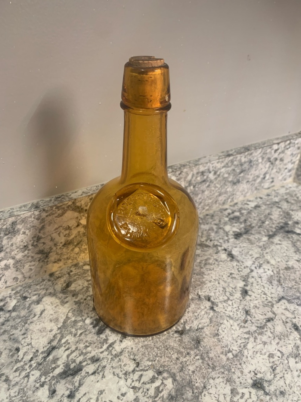 Amber Glass Bottle with Embossed Medallion